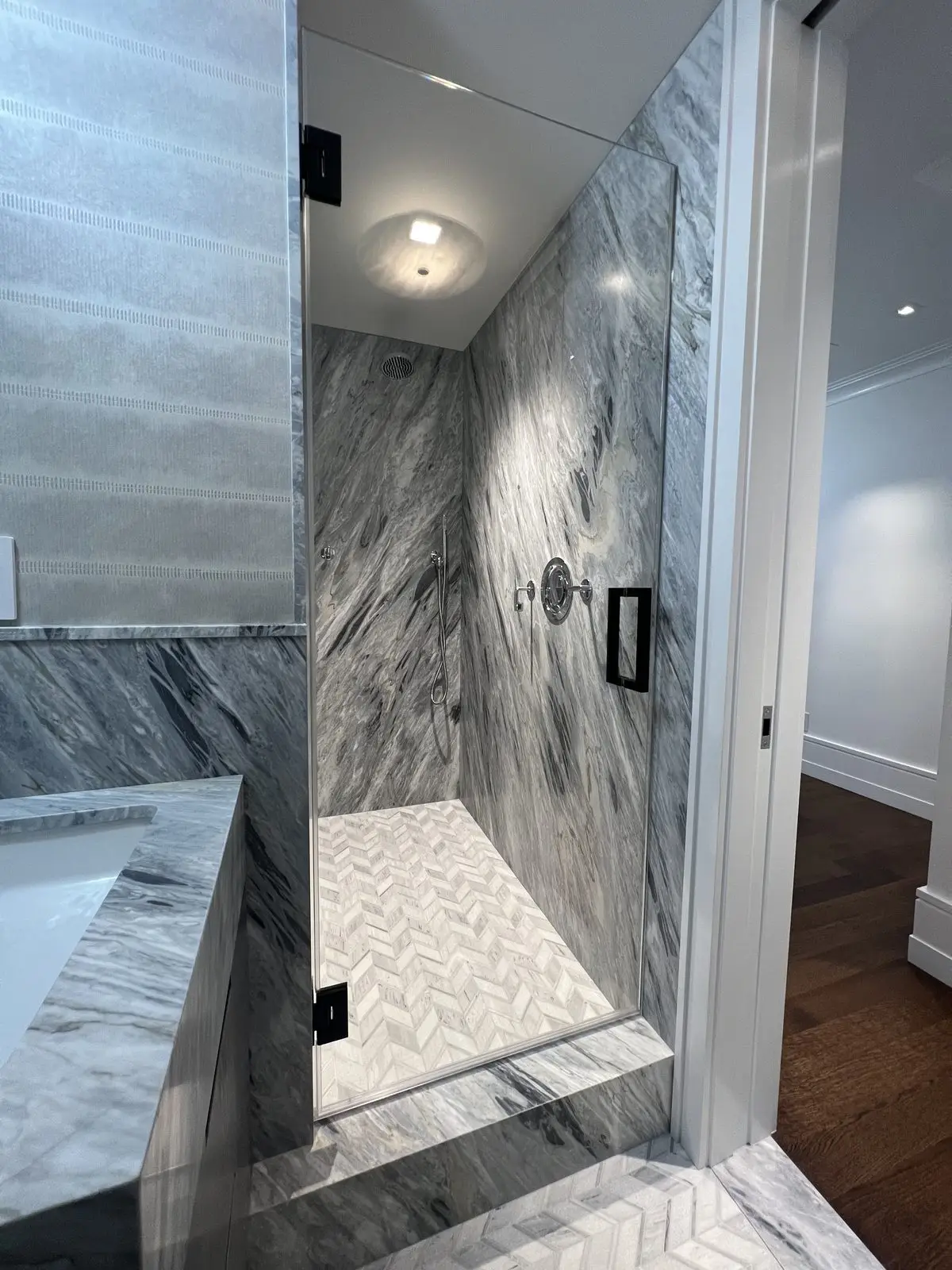 single door in marble with matte black hardware